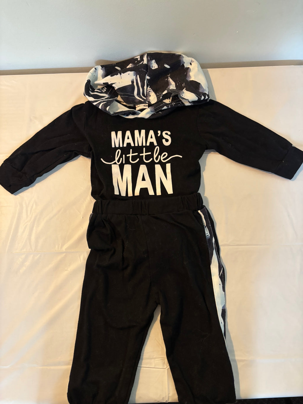 Baby boy's two-piece outfit  "MAMA'S little MAN" (printed in white) matching pants with a black and white abstract print stripe down the side